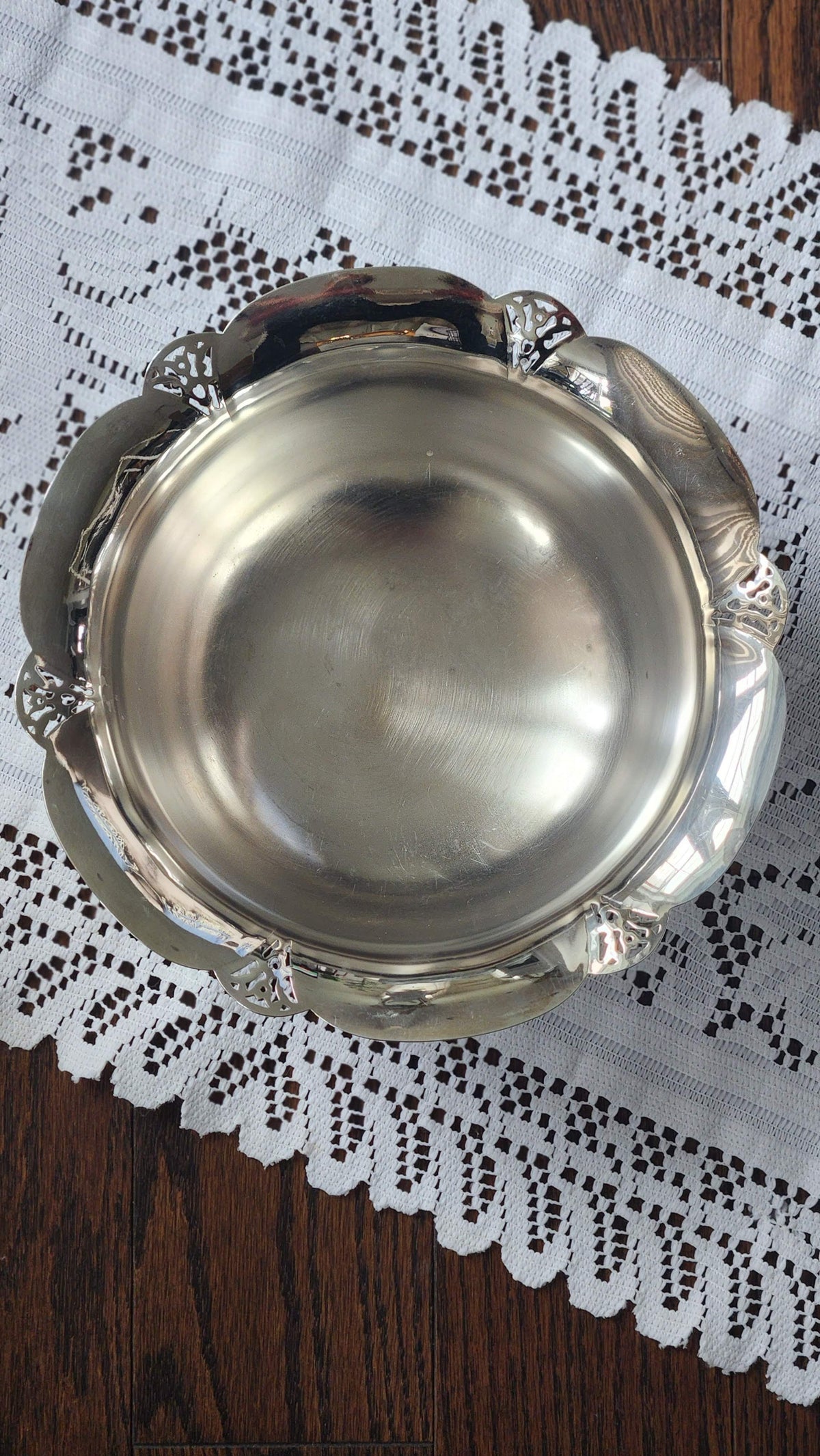 Top view of silverplate bowl showing scalloped pierced rim and surface marks inside
