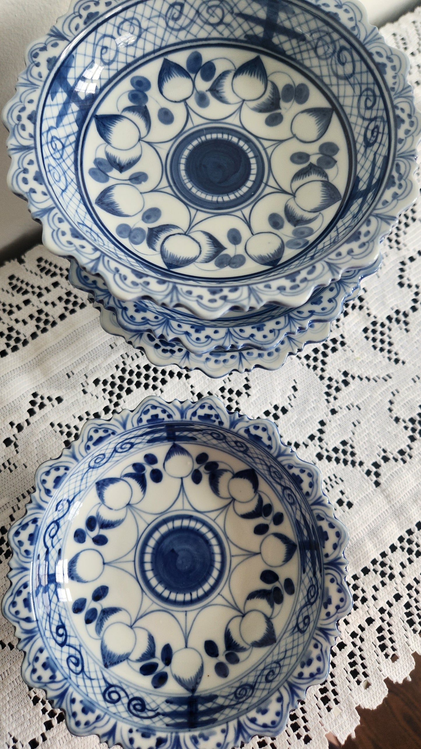Set of 4 blue and white scalloped porcelain pedestal bowls, top view