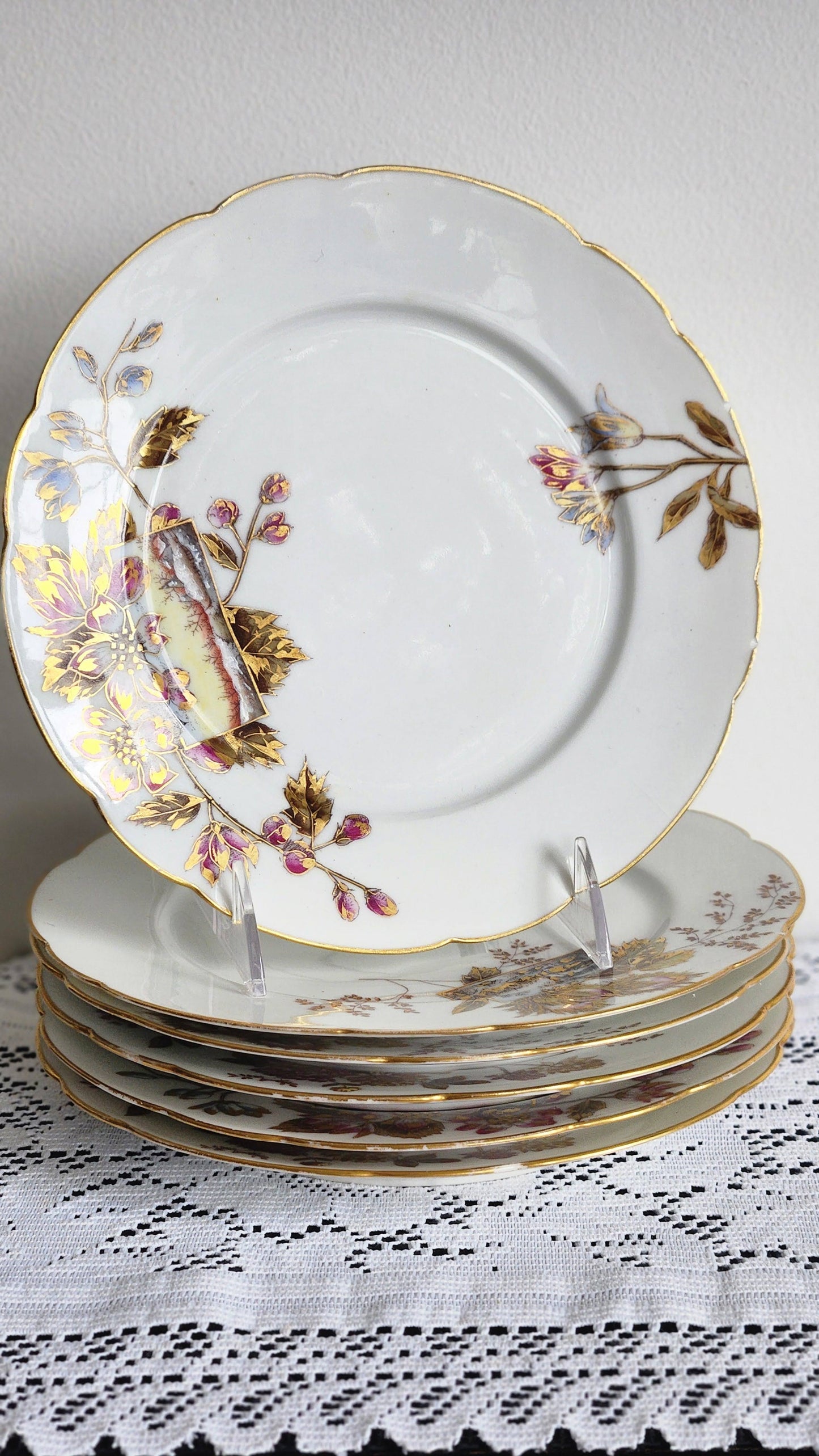 Set of 6 antique H. Delinieres Limoges dinner plates stacked, full view showing scalloped gold rim