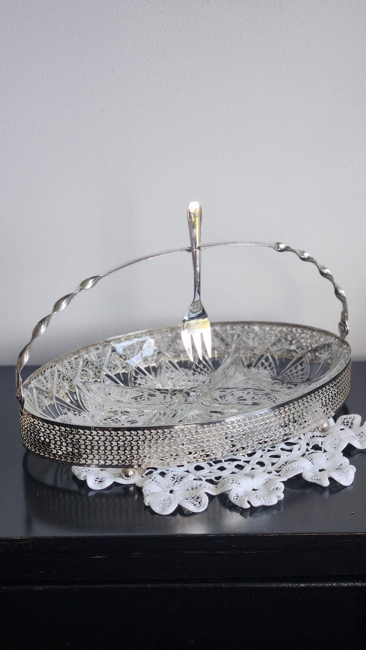 Oval silverplate relish server with pressed-glass insert, pierced gallery, swing handle, and serving fork