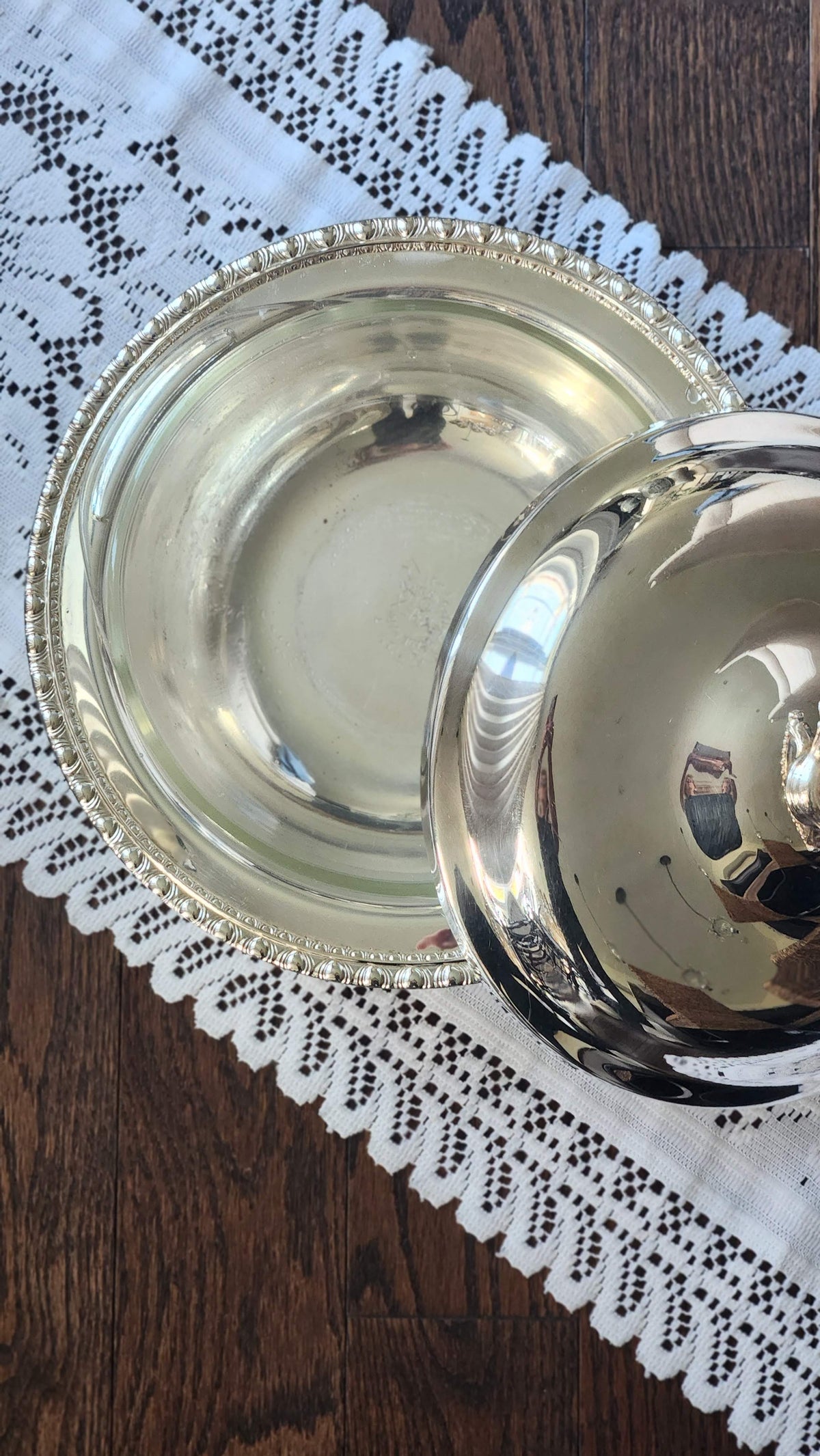 Silverplate casserole with lid lifted to show the interior