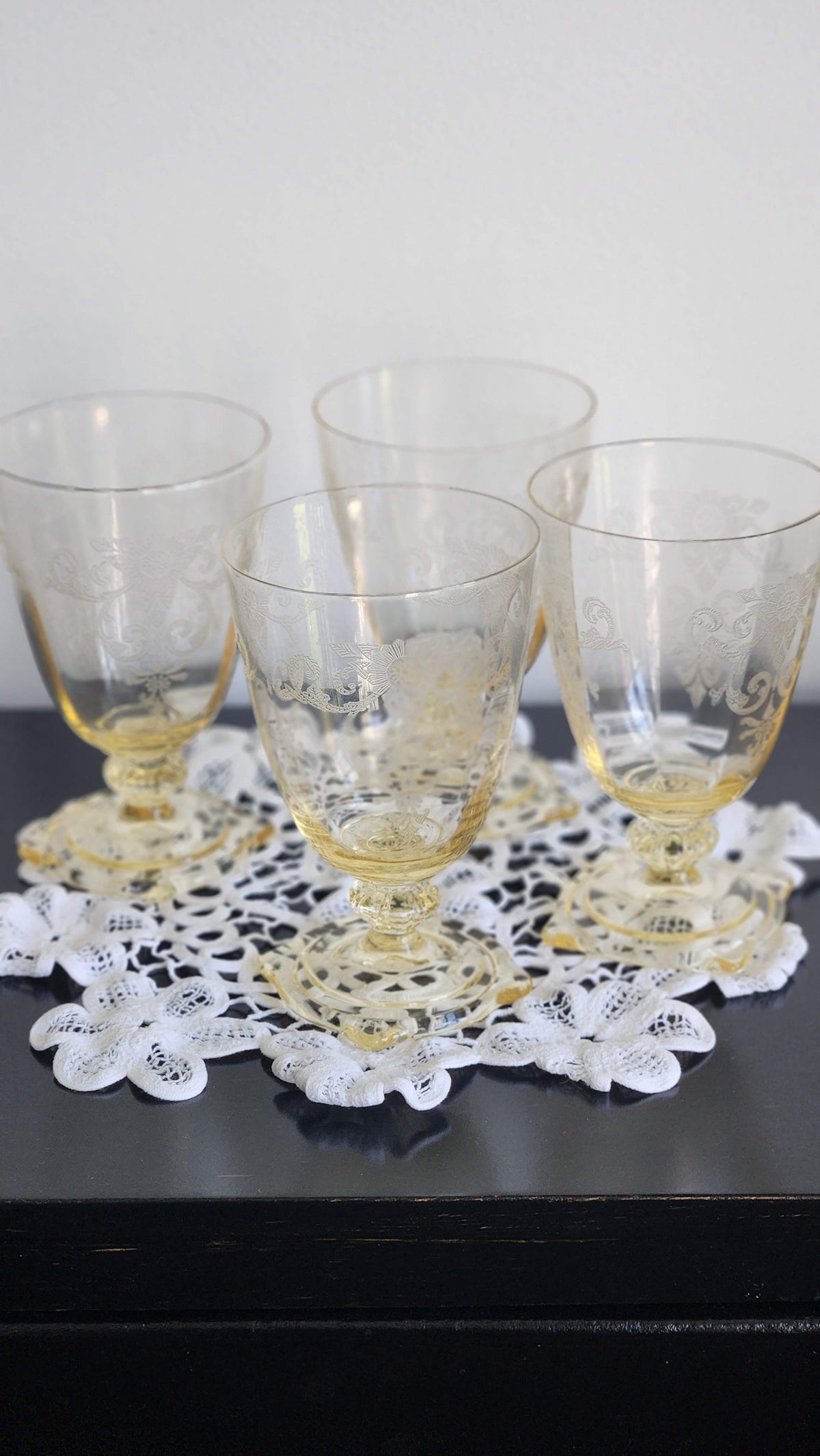 Set of four topaz yellow etched glass footed tumblers with square bases