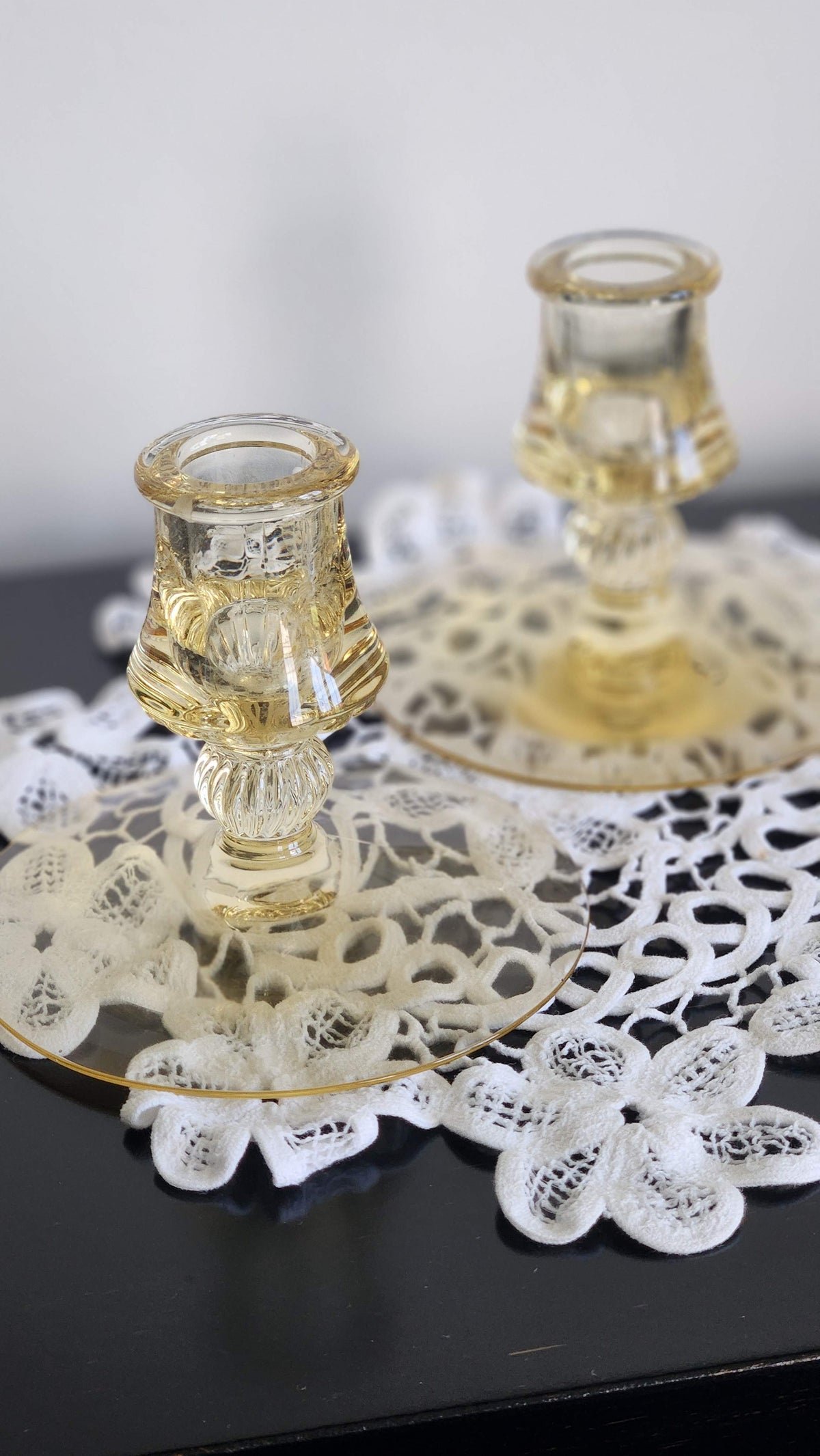 Pair of yellow topaz-colored glass candlesticks with ribbed stems and broad round bases