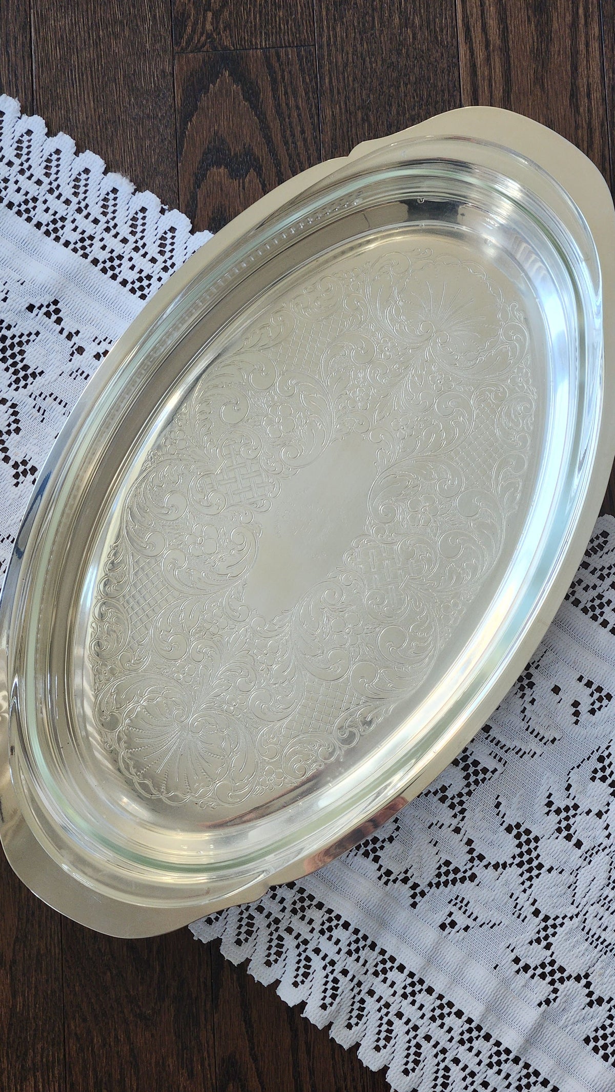 Oval silverplate casserole server with clear glass insert and chased scroll decoration