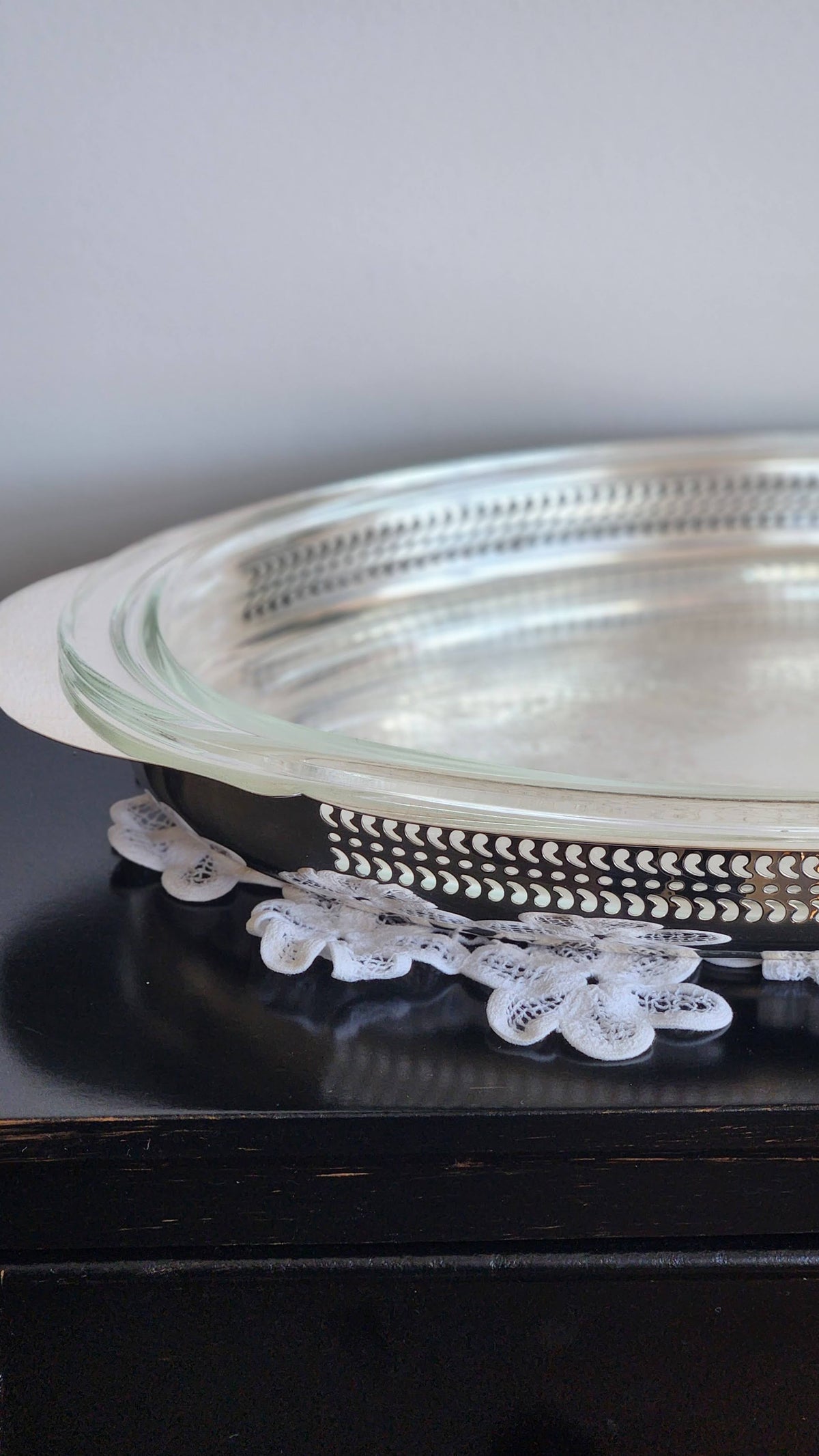 Side detail of pierced silverplate gallery and glass casserole insert