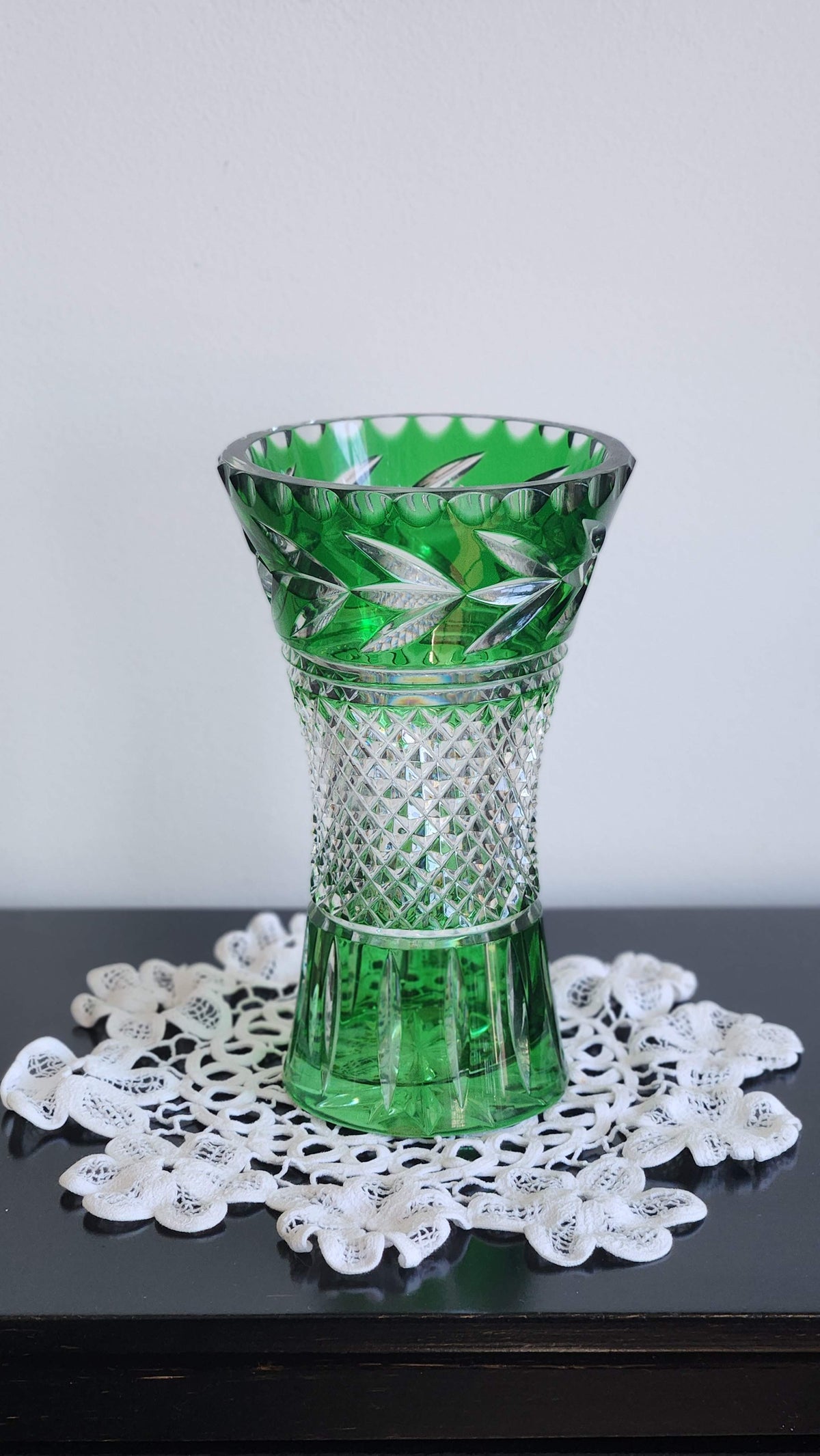 Close view of green vase rim and clear leaf-shaped cuts