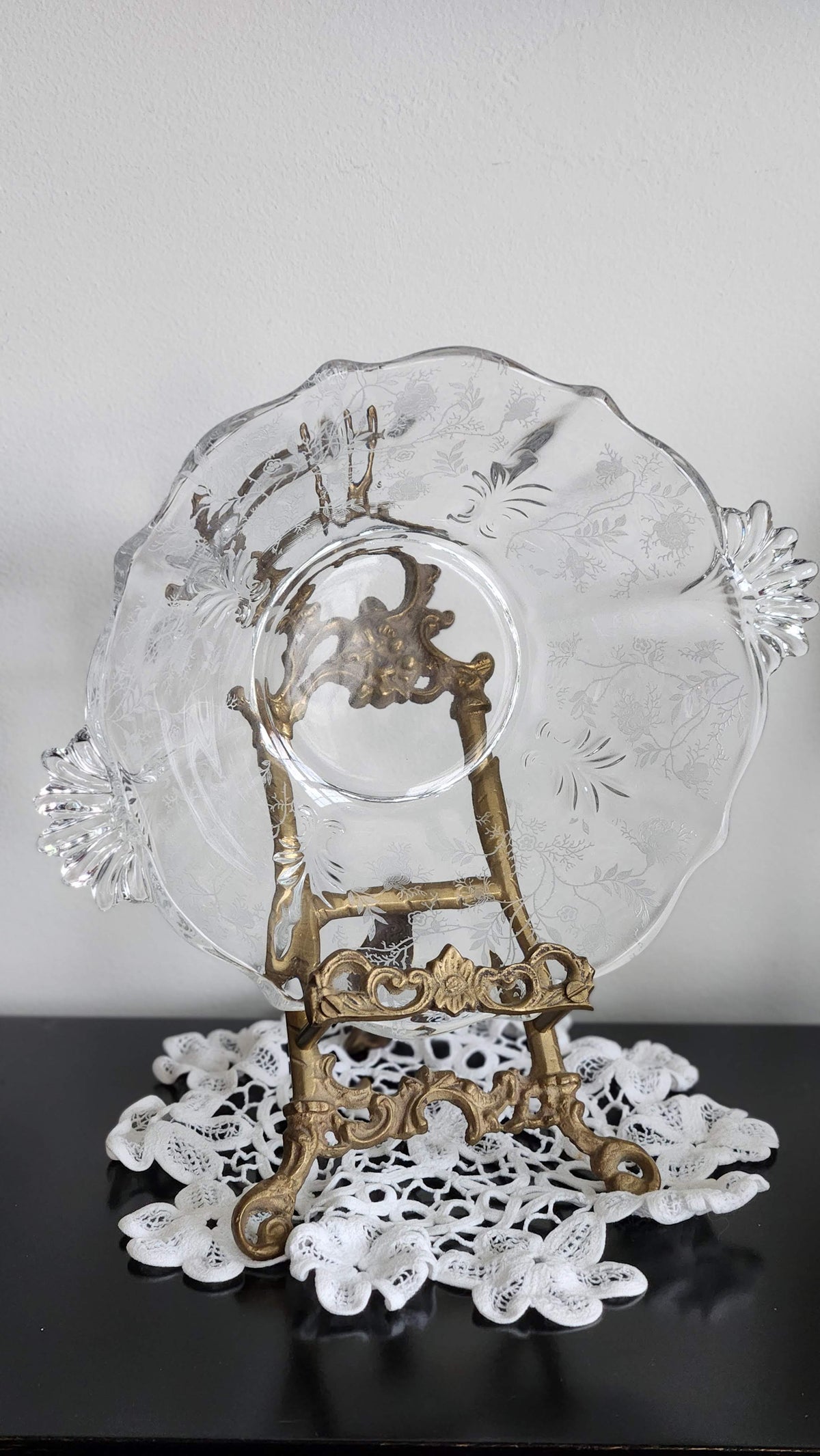 Detail of floral etching, crimped rim and fan-shaped handle on vintage glass bowl