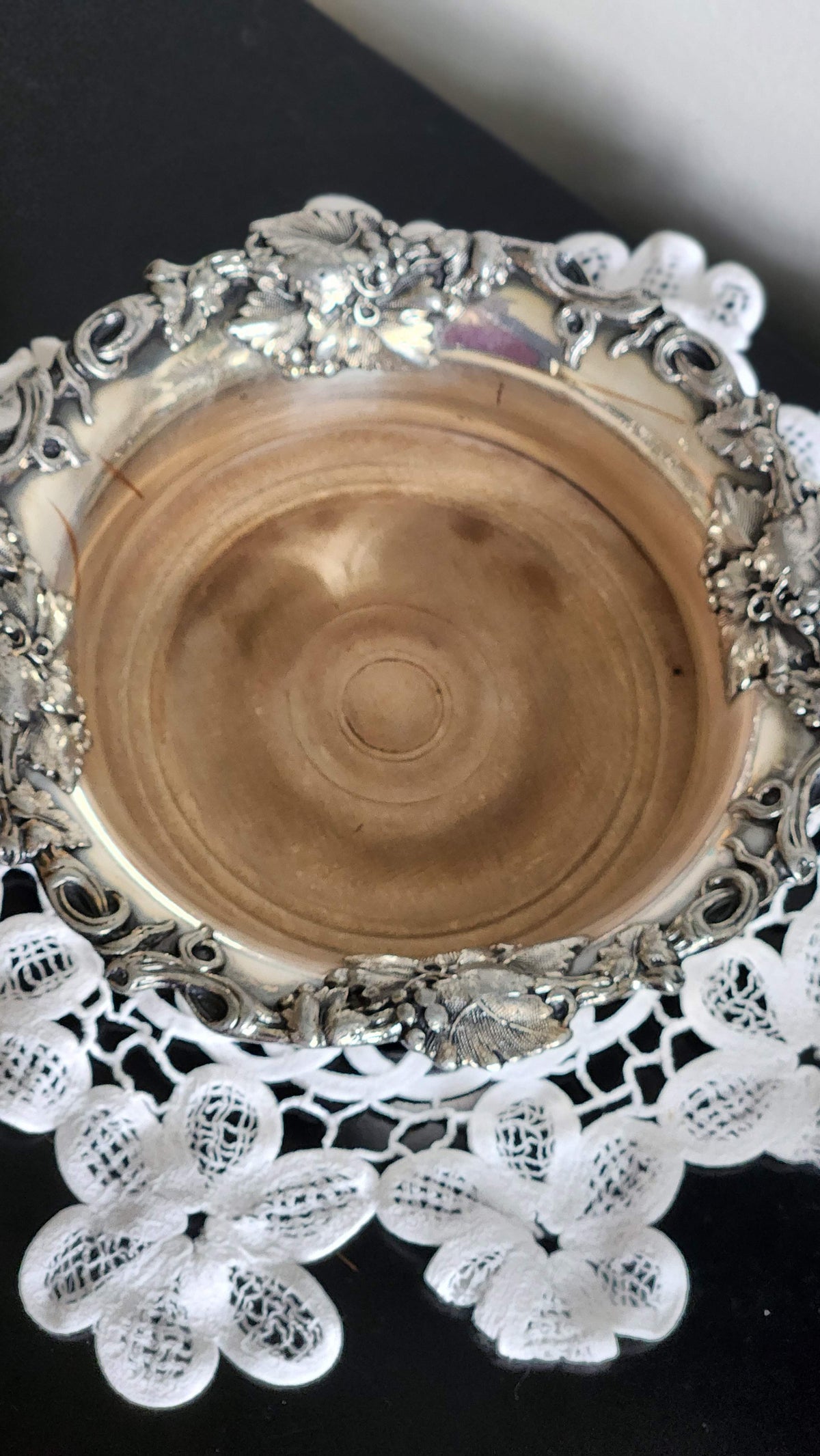 Top view of wine coaster showing turned wood base and grapevine rim