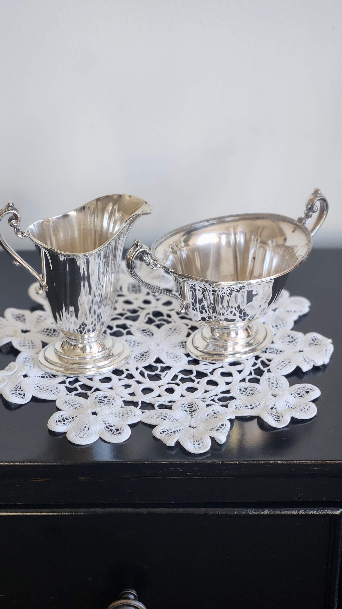 Vintage silverplate footed creamer and sugar bowl set with scroll handles